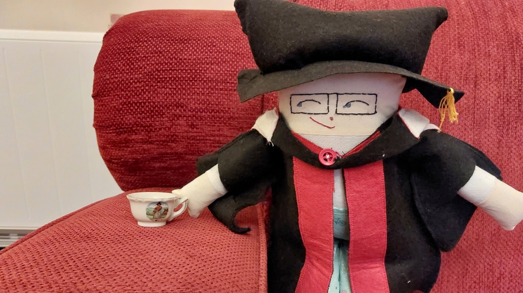Don, one of the Congress mascots, sits with a tea-cup in his hand.
