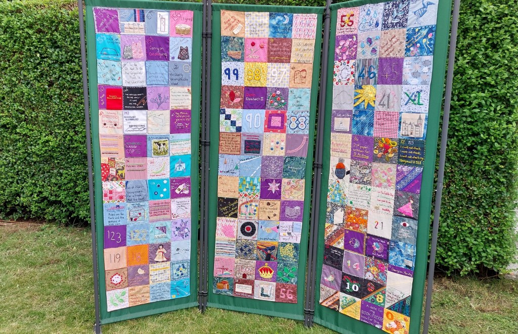 3-panel screen displaying the stitched countdown squares.  Background: a garden hedge.