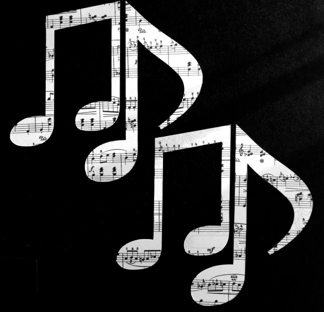 Musical notes cut out of old sheet music