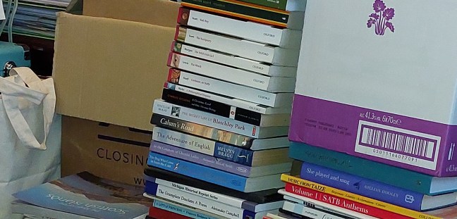 Piles of books on the floor whilst their usual room is redecorated.