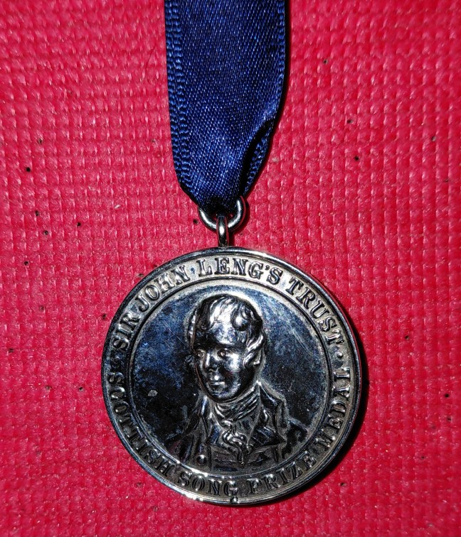 Silver Leng Medal for singing Scots songs, on blue ribbon